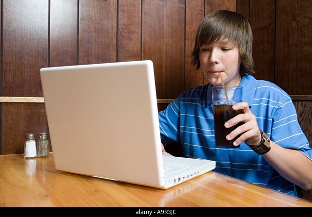teenage boy studying on computer in microsoft office 2011 for mac book